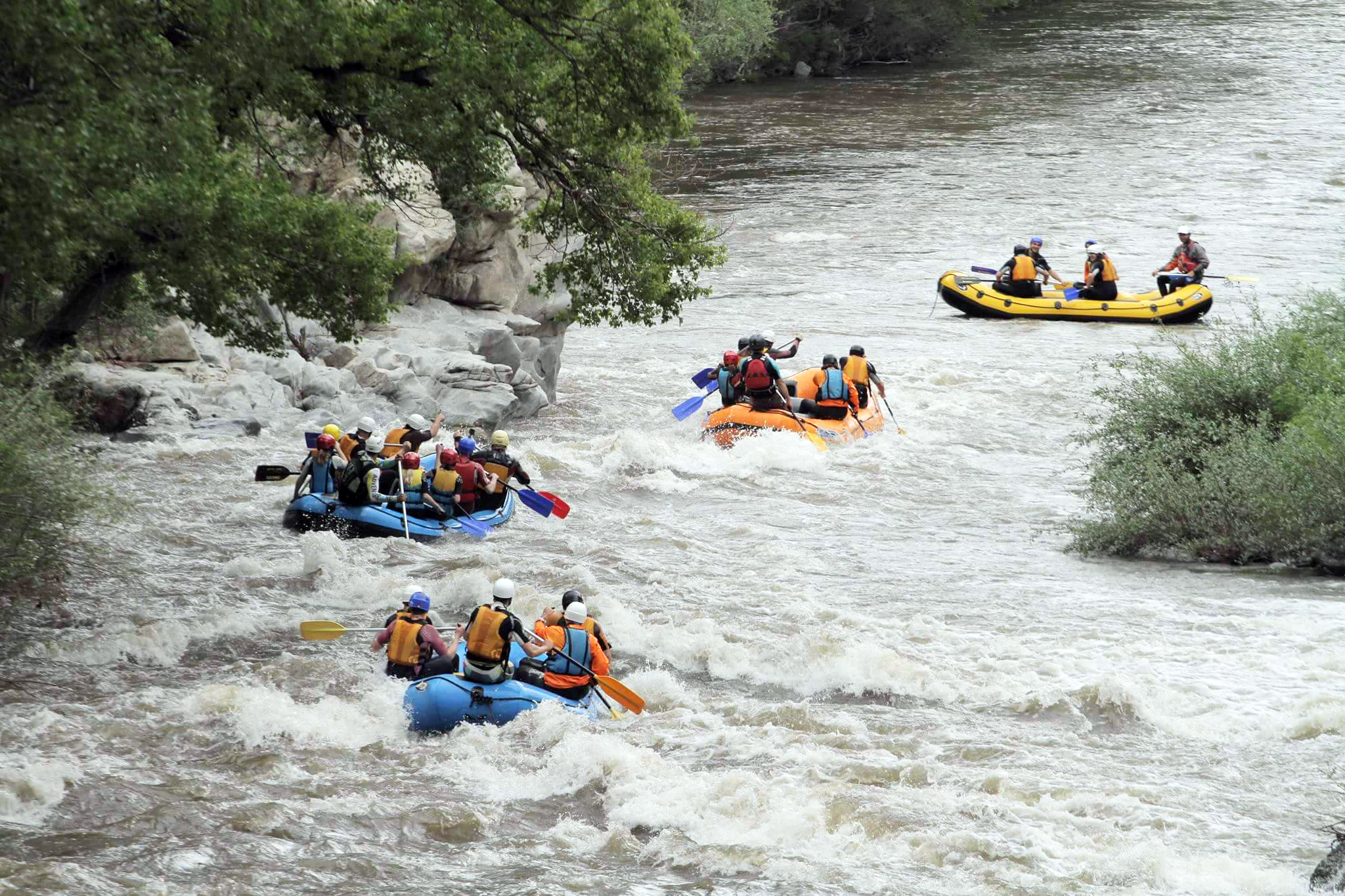 A tail of rafts rushing through a rapid in the Struma River. Retrieved from Adventure Net. 