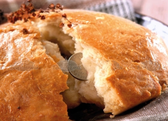 Pitka with a coin. Photo derived from https://www.bonapeti.bg/recepti/pitka-s-parichka/