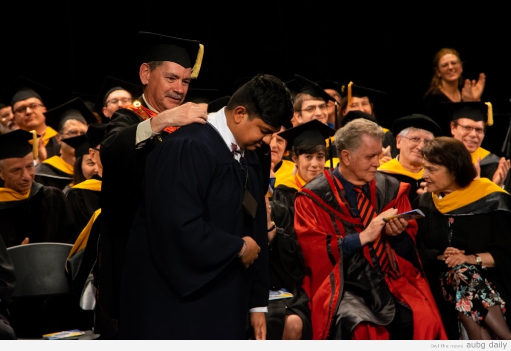 President Sullivan awarding Canagasabey; Steliyana Yordanova for AUBG Daily